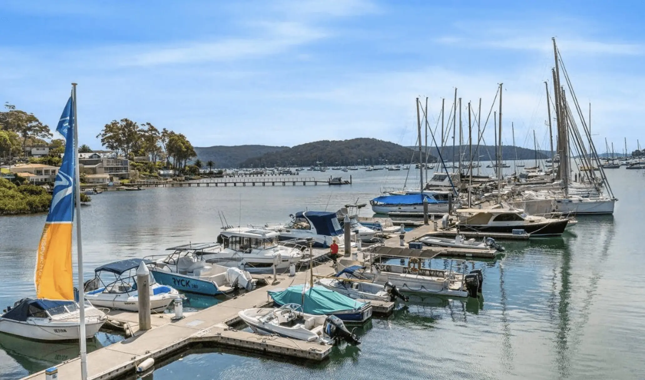 Tranquil Bayview waterfront with yachts moored on Pittwater, showcasing the peaceful lifestyle sought by Bayview property buyers